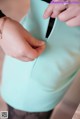 A woman is holding a zipper in her pocket.