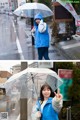 A woman in a blue jacket holding an umbrella in the rain.