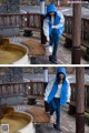 A woman in a blue and white jacket standing next to a wooden bench.