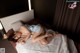 A woman laying on a bed in a bedroom.