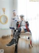 A couple of women sitting on top of a white chair.