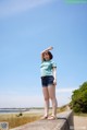 A woman standing on top of a concrete wall.