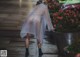 A woman walking down the street in the rain.