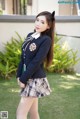 A young woman in a school uniform posing for a picture.